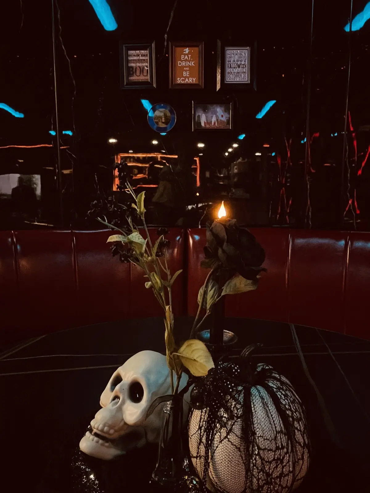 Skull, black roses and candlelight on a Halloween table at Nexus Lounge